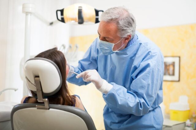 A dentist examining a patient's teeth