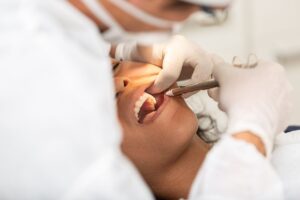 A female patient being numbed by a the dentist at Summit Family & Cosmetic Dentistry prior to a tooth extraction procedure.
