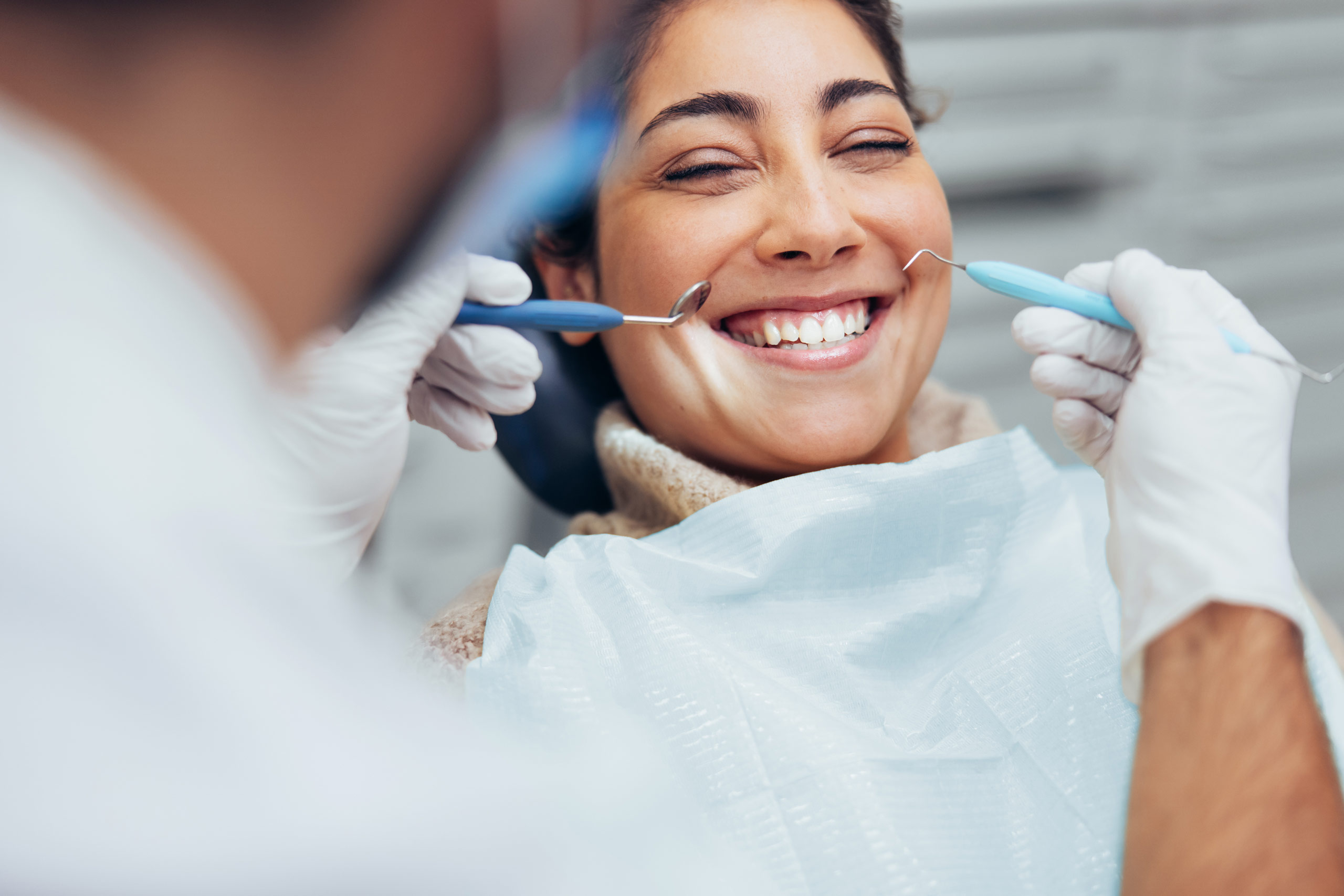 woman smiling during a regular dental checkup at summit dentistry spokane