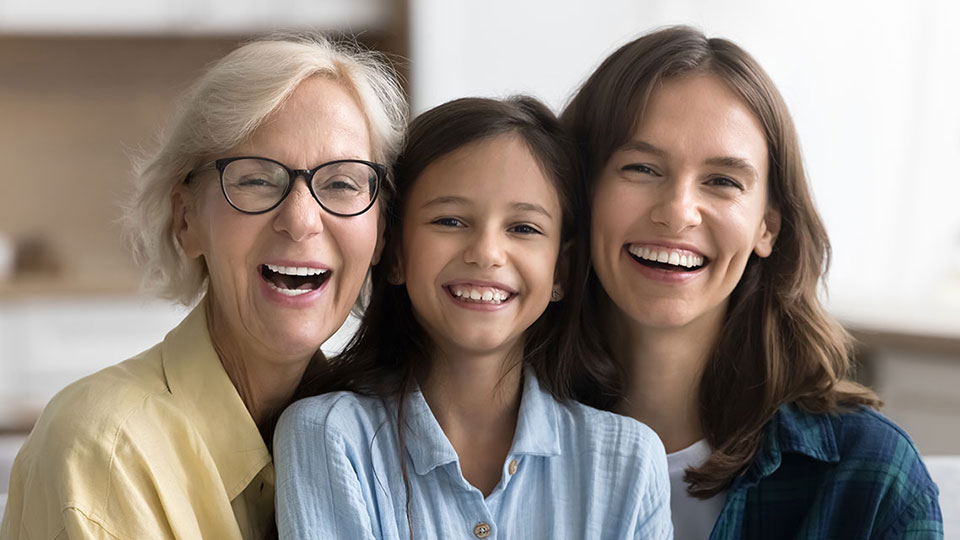 grandmother, mother, and granddaughter all smiling
