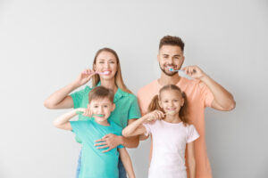 family brushing their teeth together